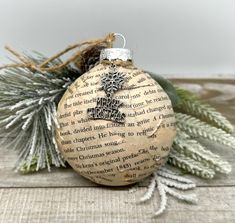 a wooden ornament sitting on top of a table next to pine cones and branches