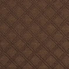 a brown and black rug with diamond shapes on the bottom, it is very dark