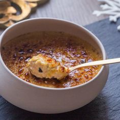 a white bowl filled with food on top of a table