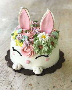 a cake with flowers and bunny ears on it