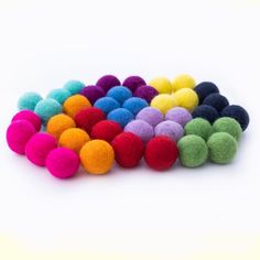 multicolored pom - poms on white background