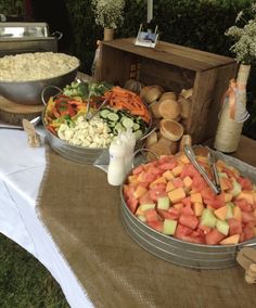 an assortment of food on a table at a wedding or other function, including carrots, cauliflower and cucumbers