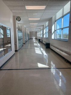 an empty hallway with lots of windows in it