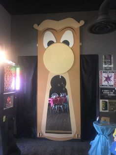 a large cardboard cut out of a cartoon character on the side of a wall in a restaurant