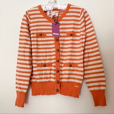 Cute Tommygirl Cardigan Striped Orange And White. Has Buttons Along The Front And Pockets. Cute Cotton Cardigan With Button Closure, Cotton Cardigan With Button Closure, Cute Style, White Tommy Hilfiger Cotton Sweater, Cute Cotton Sweater With Buttons, Cute Cotton Buttoned Sweater, Playful Cotton Cardigan For Spring, Tommy Hilfiger Cotton Sweater For Fall, Preppy Long Sleeve Cotton Cardigan, Preppy Cotton Cardigan With Long Sleeves