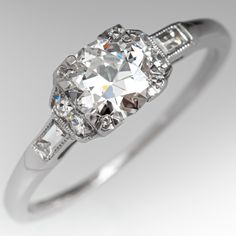 This circa 1940s engagement ring features milgrain details and is centered with a round transitional brilliant cut diamond that weighs 0.62 carats, in a square four-prong setting. The shoulders are each bead set with two (2) round single cut diamonds and bezel set with one (1) baguette cut diamond. The ring measures 5.8mm at the top, rises 4.7mm above the finger, tapering to 0.7mm wide and 1.0mm thick at the base of the shank. The ring is currently a size 6.5 and we offer complimentary resizing Classic Cushion Cut Diamond Ring With Single Cut Diamonds, Gia Certified Classic Baguette Cut Diamond Ring, Classic Gia Certified Baguette Cut Diamond Ring, Classic Diamond Ring With Single Cut Diamonds, Gia Certified Classic Cut Diamond Ring For Wedding, Classic Platinum Diamond Ring With Cushion Cut, Gia Certified Diamond Ring For Wedding, Classic Gia Certified Cushion Cut Diamond Ring, Classic Gia Certified Cushion Cut Rings