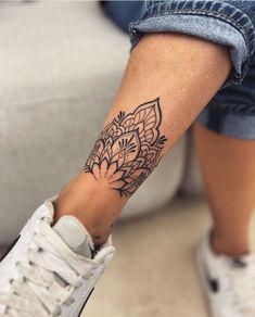 a woman's foot with a tattoo on it