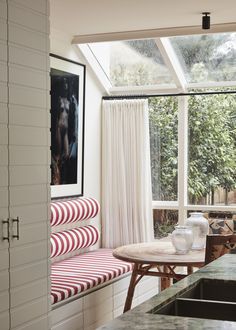 a kitchen with a table and chairs next to a window