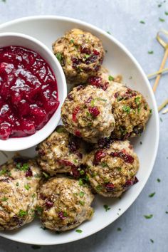 a white plate topped with meatballs and cranberry sauce