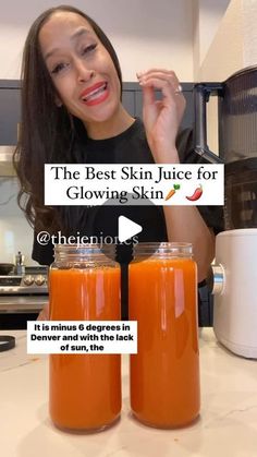 a woman holding two jars of orange juice in front of her face with the caption, the best skin juice for glowing skin