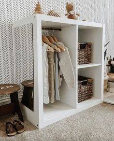 a white shelf with clothes and shoes on it