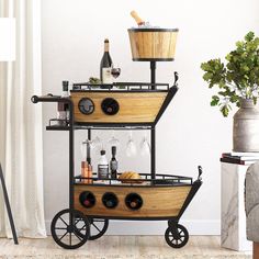 a wooden boat shaped bar cart with wine glasses and bottles on it, next to a potted plant