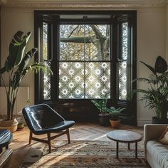 a living room filled with furniture and large windows