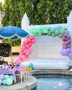 an outdoor pool decorated with balloons and streamers