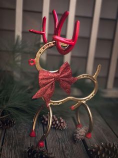 a pair of reindeer antlers with red bows on them