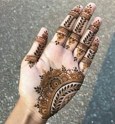 a person's hand with henna tattoos on it