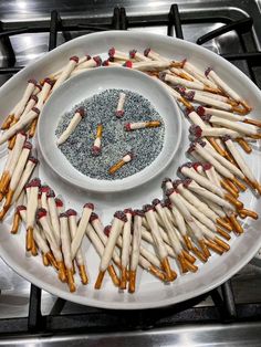 a white plate topped with lots of different types of matches on top of a stove