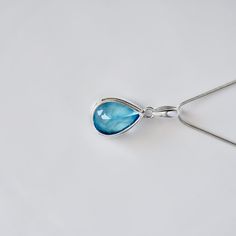 About The Stone A lustrous and brilliant gem, it is the birthstone for December. It is said that blue topaz helps in improving communication and self-expression, and cool down angry tempers when inflamed. About The Product A beautiful everlasting design, this pendant has a stunning pear drop shaped Blue Topaz. Combine elegance and personality with this masterpiece! * Metal: 925 Sterling Silver * Finish: Polished * Stone Name: Blue Topaz * Stone Size: 13*18 MM Pear * Number Of Pieces: 1 * Stone C Boho Crystal, Blue Topaz Pendant, Topaz Pendant, Topaz Necklace, Blue Topaz Stone, November Birthstone, Aquamarine Rings, Topaz Stone, December Birthstone