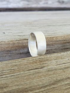 "Our Sterling Silver cuff thumb ring is amazing. Sanded for a satin finish, it's simple and elegant. Easily adjustable. The ring pictured is roughly 1/4\" wide. The cuff can be customized for different ring sizes. Small gift box included. The Sterling Silver consists of 92.5% Silver and 7.5% of an alloy, mainly consisting of copper. In some, the copper reacts with the skin and can turn it green. The 935 Silver ring consists of 93.5% silver and 6.5% of of an alloy. The color is closer to fine sil Minimalist Sterling Silver Wide Band Ring For Anniversary, Minimalist Rings With Brushed Finish For Gift, Minimalist Rings With Brushed Finish As Gift, Minimalist Brushed Finish Promise Ring, Minimalist Adjustable Wide Band Ring For Wedding, Minimalist Adjustable Wide Band Wedding Ring, Minimalist Everyday Jewelry With Brushed Finish, Silver Minimalist Wide Band Ring For Wedding, Minimalist Silver Wide Band Ring For Wedding