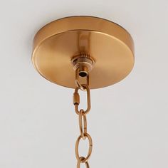 a close up of a light fixture with a chain hanging from it's side