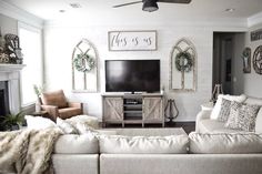 a living room filled with furniture and a flat screen tv on top of a fireplace