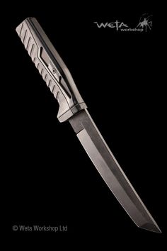 the large knife is on display against a black background