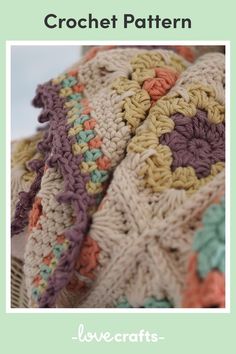 a crocheted blanket sitting on top of a wicker basket