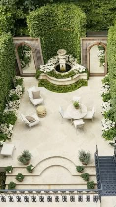 an aerial view of a patio with chairs and tables surrounded by greenery, shrubs and trees