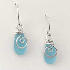 "Mermaid Tear Drop Earrings ~ 20 gauge, sterling silver wire ~ in a SPIRAL, accenting the matte glass. This is NOT beachglass, rather they are pressed beads from the czech republic. The glass does, however, look very much like beachglass They hang 1 1/4\" and are very light and super comfortable! A great, everyday earring, that evokes the spirit of the sea ~ Arrives, thoughtfully gift packaged on CRD printed earring card & artisan bio. Ready for gift giving! FREE SHIPPING in the USA" Mermaid Tears, Long Branch, Tear Drop Earrings, Earring Card, Earring Cards, Everyday Earrings, Tear Drop, Teardrop Earrings, Silver Wire