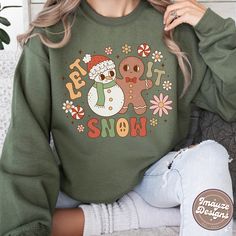 Let It Snow Christmas Sweatshirt Funky Christmas Snowman Retro Vintage Groovy Style Christmas Jumper Gift For Her Womens Ladies Sweater Welcome to ImayzeDesigns! ✨ Get ready to spread peace, love, and snowflakes with our groovy 'Let it Snow' Christmas sweatshirt! This season is all about celebrating in fun, festive style ❄️🌈✌️ THE SWEATSHIRT This classic Gildan 18000 unisex heavy blend crewneck sweatshirt is pure comfort! These garments are made from polyester and cotton, a combination that ensures designs stay looking fresh and beautiful. ⭐ High quality and very comfortable for everyday wear ⭐ Medium-heavy fabric blend of 50% cotton and 50% polyester (8.0 oz/yd² (271.25 g/m ⭐ Made using 100% ethically grown US cotton ⭐ Cosy and comfortable fit with knit collar ⭐ Tear away label ⭐ Runs tr Cute Christmas Sweatshirt With Letter Print, Retro Graphic Print Sweatshirt For Winter, White Retro Winter Sweatshirt, Cute Christmas Graphic Print Sweatshirt, Christmas Green Sweatshirt With Graphic Print, Cute Christmas Sweatshirt With Graphic Print, Playful Winter Sweatshirt With Cartoon Print, Retro Winter Sweatshirt With Cartoon Print, Christmas Green Graphic Print Sweatshirt