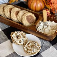 some cookies are sitting on a plate next to other food and pumpkins in the background