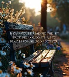 a bench sitting in the middle of a field with daisies and flowers on it