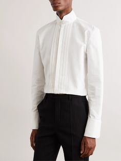 SAINT LAURENT's subtle alterations help you personalise black tie dress codes. This bib-front tuxedo shirt has been tailored in Italy from crisp cotton-poplin and features a tall grandad collar that secures with mother-of-pearl buttons. Feel free to skip the bow tie. Tuxedo Shirt For Men, Saint Laurent Collection, Grandad Collar Shirt, Tux Shirt, Mens White Dress Shirt, Black Tie Dress Code, Tuxedo Shirt Men, Banded Collar Shirts, Black And White Tuxedo