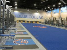 an empty gym with blue and orange mats