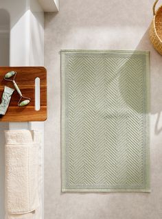 an overhead view of a bathroom area with towels and bath accessories on the counter top