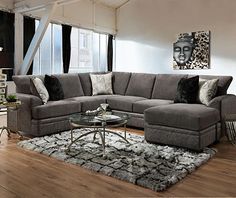 a living room filled with furniture and a rug on top of a hard wood floor