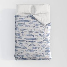 a bed with blue and white fish on it