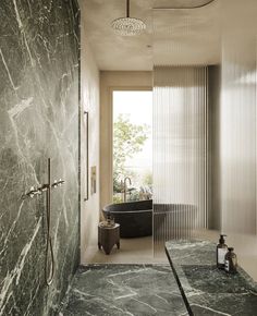 a bathroom with marble walls and flooring next to a bathtub in the corner