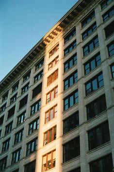 a tall building with lots of windows next to a traffic light