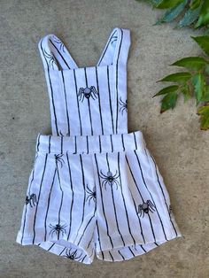 This beautiful pinafore romper is the perfect unisex garment! It's extremely versatile and can be styled in so many ways! Wear it as is in warm weather or layered with long sleeve shirts and cute socks or tights in cooler weather. It is super soft and comfortable for your little, featuring adjustable straps and an elastic waistband so it will grow as your child does. 100% Cotton Flannel Wash on Delicate Cycle Dry on Low or Lay Flat to Dry Cute Summer Jumpsuits And Rompers With Bib Front, Cute Bib Front Jumpsuits And Rompers For Summer, Beach Cotton Shortalls Overall, Cute White Jumpsuits And Rompers For Fall, Cute Spring Shortalls With Bib Front, Cute Bib Front Shortalls For Spring, Cute Bib Front Overalls For Summer, Summer Shortalls With Suspenders And Bib Front, Playful Summer Shortalls