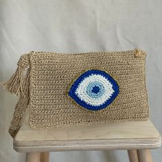 a crocheted bag with an eye on it