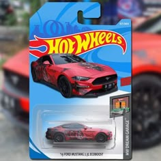 a red toy car with flames on it's hood and the words hot wheels