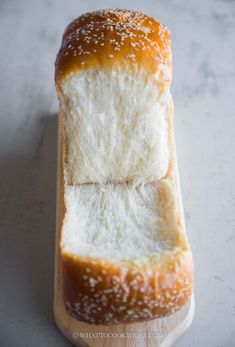 two loaves of bread sitting on top of a cutting board next to each other