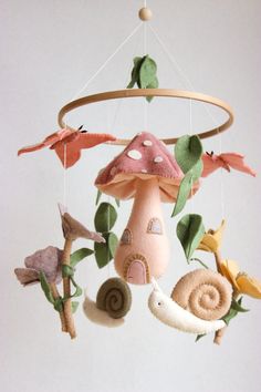 a mobile made out of felt with mushrooms and birds hanging from it