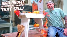 a man is sitting on a table with pumpkins and other decorations around him that spell out the word, high profits woodworking projects that sell