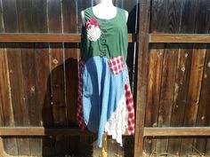 a woman's dress on display in front of a wooden fence