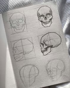 a piece of paper that has some drawings on it with different types of skull heads