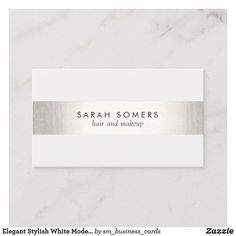 a white and silver business card with the name of a hair stylist on it