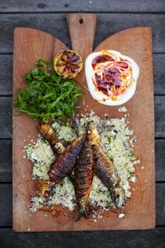 an overhead view of some food on a cutting board with sauces and other ingredients