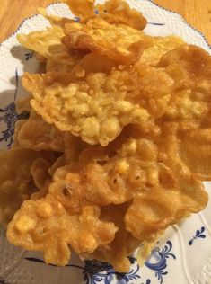 some fried food on a blue and white plate